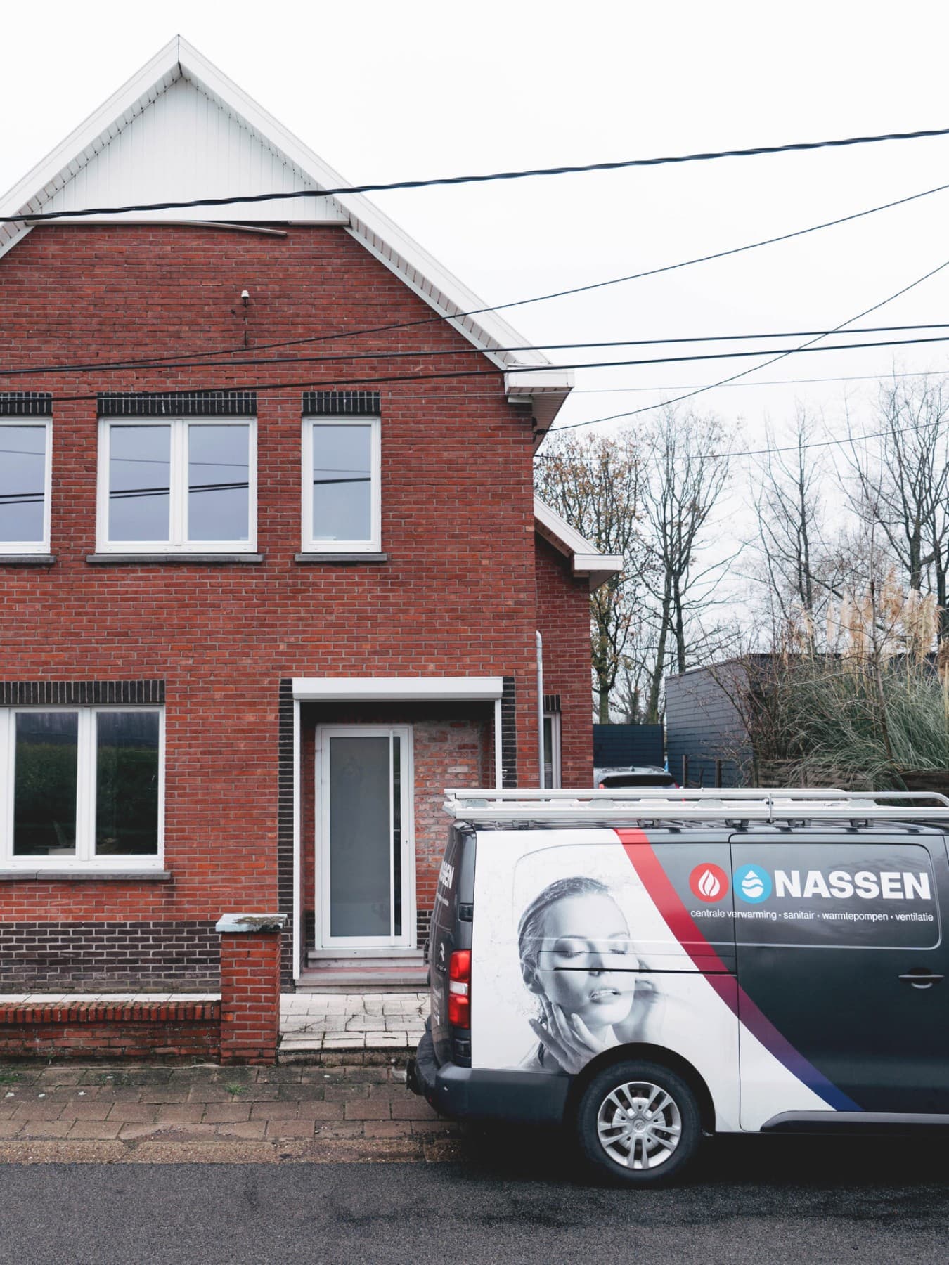 A pickup truck is parked in front of a red-brick building