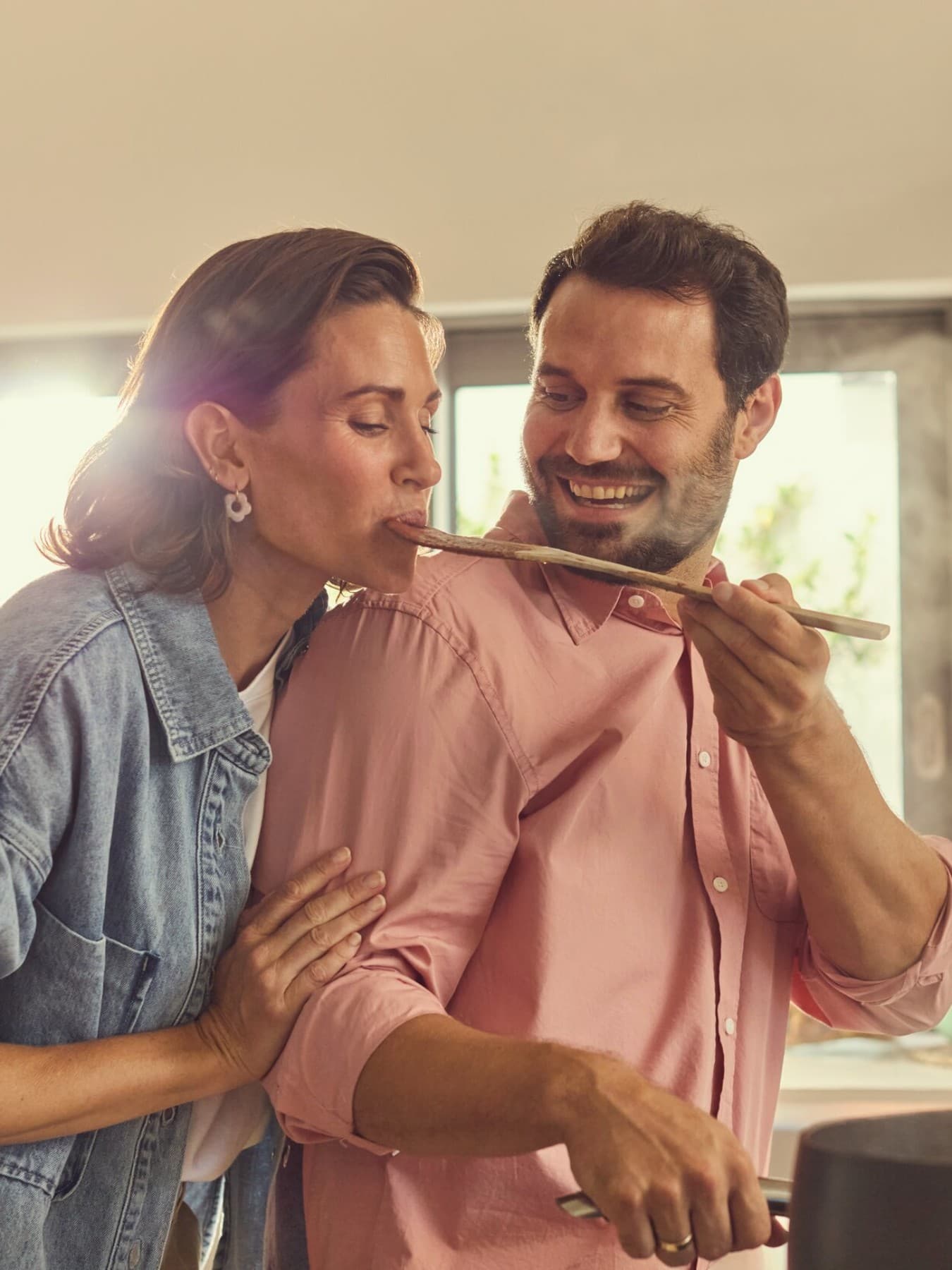 Man laat een vrouw proeven van een houten lepel, op de achtergrond zie je een Vaillant ecoTEC plus condensatiegasketel